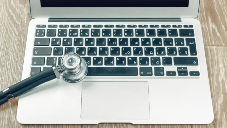 Stethoscope on a laptop representing clinical context and telehealth review.