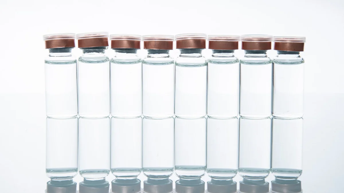 Row of neutral laboratory sample vials used for research documentation.